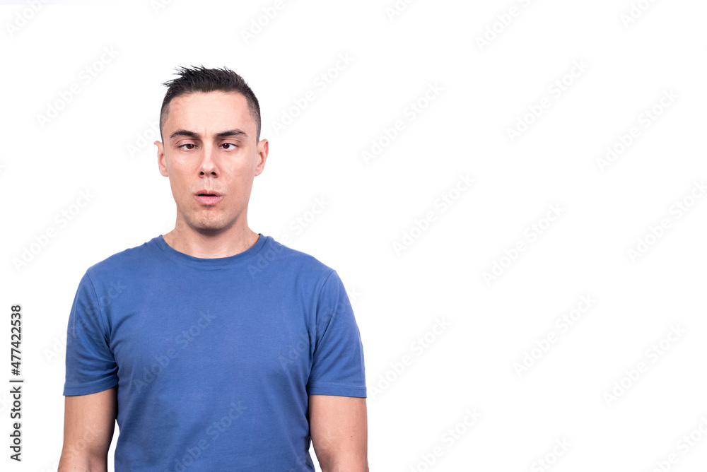Squint-eyed adult man grimacing with tired expression Squint-eyed adult man grimacing with tired expression