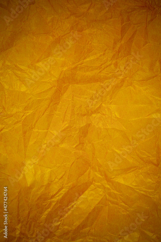 Crumpled gold paper recycling background.