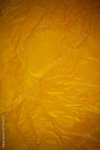 Crumpled gold paper recycling background.