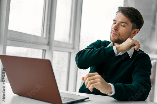 Man sitting at his desk laptop technology working online