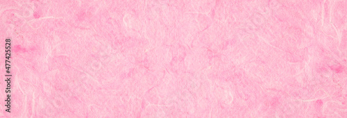 background of light pink, textured, handmade mulberry pape.