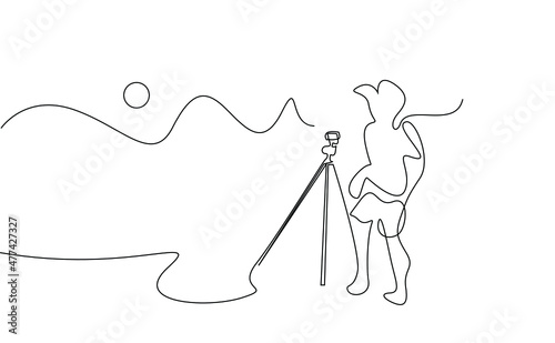 nature photographer taking pictures with camera and tripod