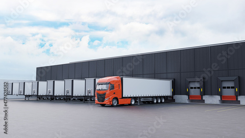Truck and trailers in front of a warehouse loading dock.