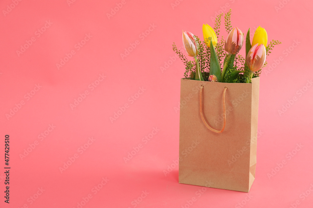 Paper bag with flowers on pink background Stock Photo | Adobe Stock