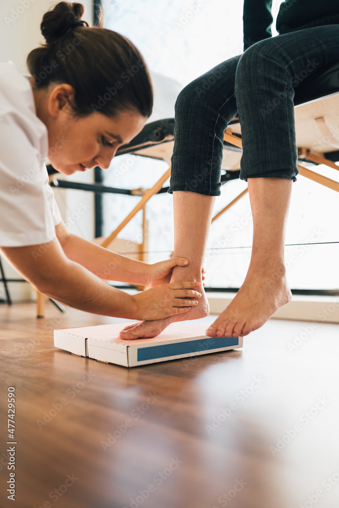 Chiropodist taking the shape of a patient's foot with a foam mold for the manufacture of a special insole. Chiropodist taking the shape of a patient's foot with a foam mold for the manufacture of a special insole.