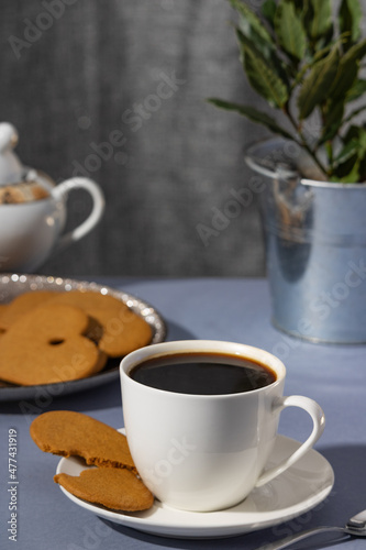 Coffee and gingerbread. Sweet cookies and coffee on a festive background. Background for a postcard good morning. snack.Christmas heart-shaped gingerbread cookies. 