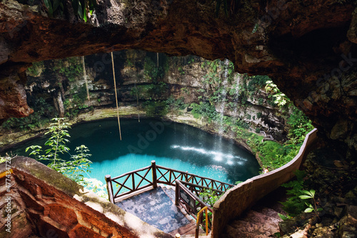 the blue water of the cenote of Yucatan in Mexico at a sunny day photo