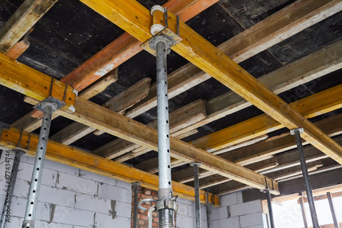 The supports of monolithic floor formwork at a construction site. Telescopic props for concrete flooring. Construction of a modern apartment building  photo