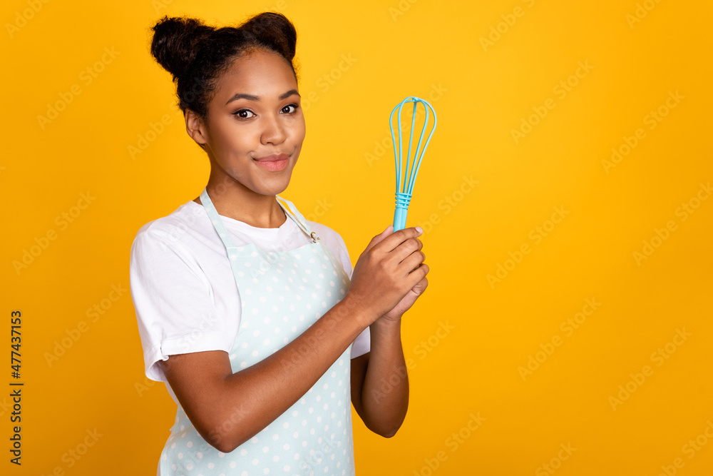 Profile side photo of young pretty african woman hold whisk tools cooking breakfast isolated over yellow color background Profile side photo of young pretty african woman hold whisk tools cooking breakfast isolated over yellow color background