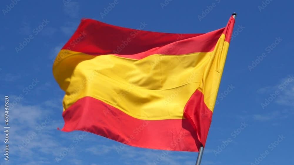 Spanish Flag Waving in the Wind in Slow Motion Close Up with blue sky background. High quality 4k footage Spanish Flag Waving in the Wind in Slow Motion Close Up with blue sky background. High quality 4k footage