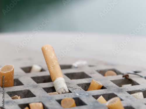 cigarette inside ashtray in my house photo