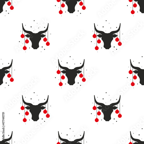 Seamless pattern. Bull head with red christmas tree toy balls on horns, snow and stars.