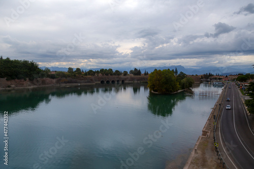 beautiful landscape with reflection in calm water of river with dramatic clouds on the sky 