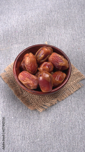 Dates in wooden bowl on background. dried dates fruit.