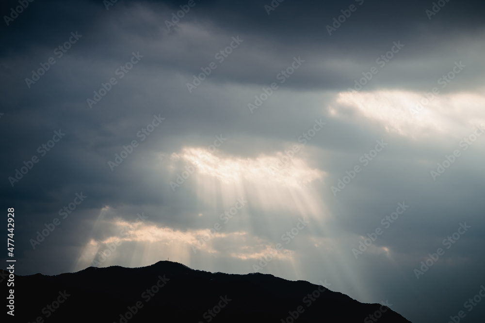 The sunlight shining through the clouds The sunlight shining through the clouds
