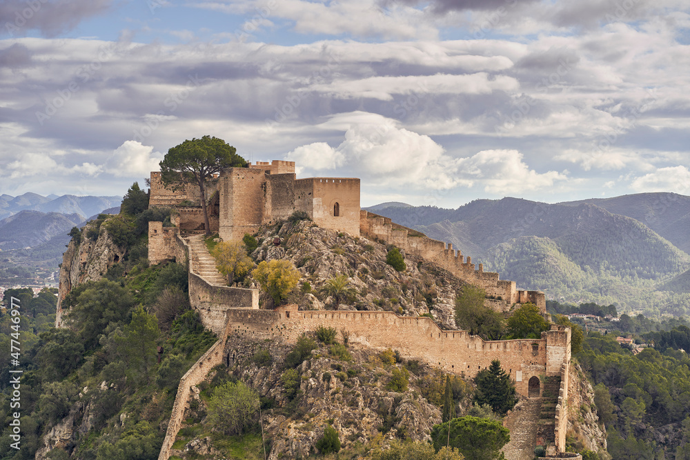 The medieval castle of Xativa against a dramatic and bright sky after the rain. District of Valencia. Spain