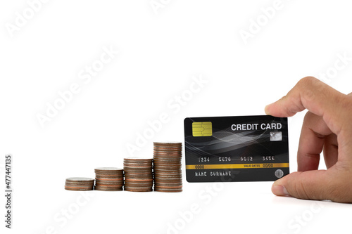 A man hand holding black credit card with coins stacking placed on the side isolated on white background, online shopping and banking concepts