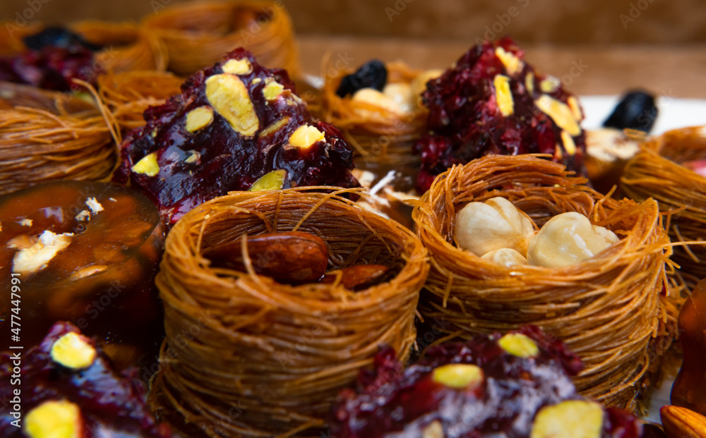 Traditional multi-colored arabic sweets baklava, lokum, muska pestili and nuts assortment. Top view.