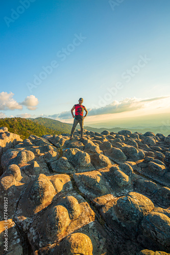 Lan Hin Pum National Park  Thailand Tourist Asian man trekking  traveling at dry rocks stone in Lan Hin Pum  Phu Hin Rong Kla National Park  Phitsanulok Province  Thailand. Mountains peak with park 