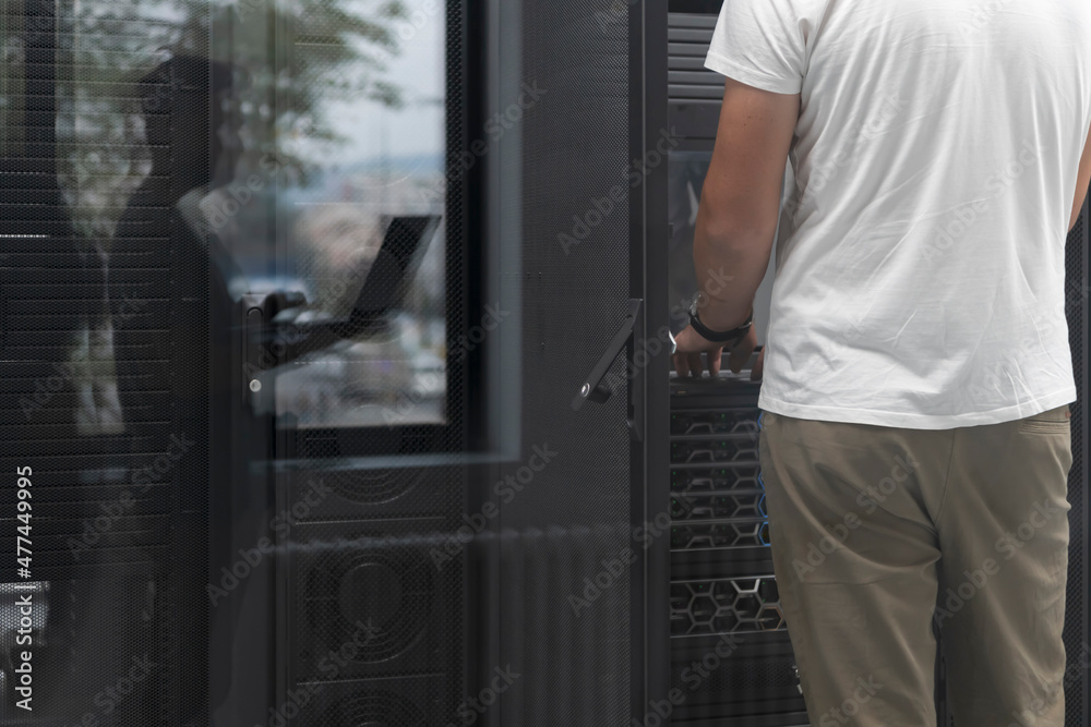  Technicians team updating hardware inspecting system performance in super computer server room or cryptocurrency mining farm.