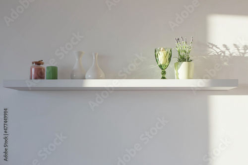 lavender and home decor on white wooden shelf
