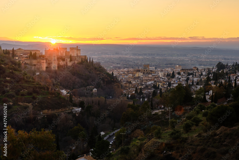 Views of the Alhambra with the city of Granada at its feet during sunset.