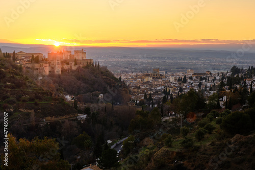 Views of the Alhambra with the city of Granada at its feet during sunset.