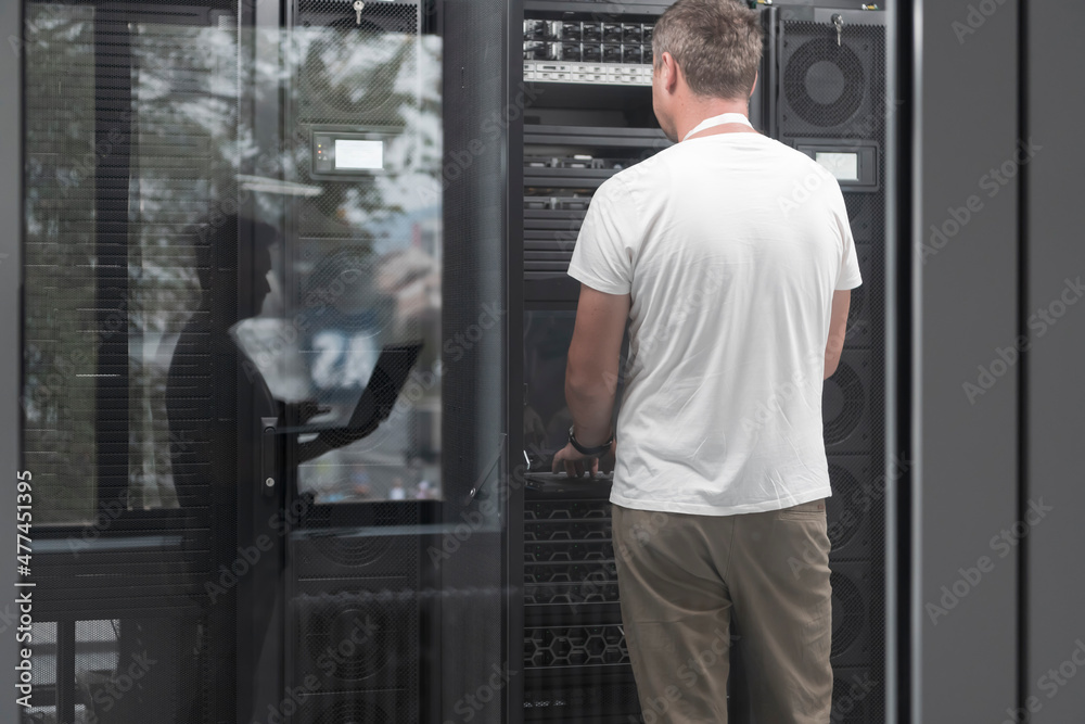 Technicians team updating hardware inspecting system performance in super computer server room or cryptocurrency mining farm. Technicians team updating hardware inspecting system performance in super computer server room or cryptocurrency mining farm.