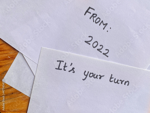 Text on letter fronts - From 2022 and It's Your Turn - New Year motivational message concept