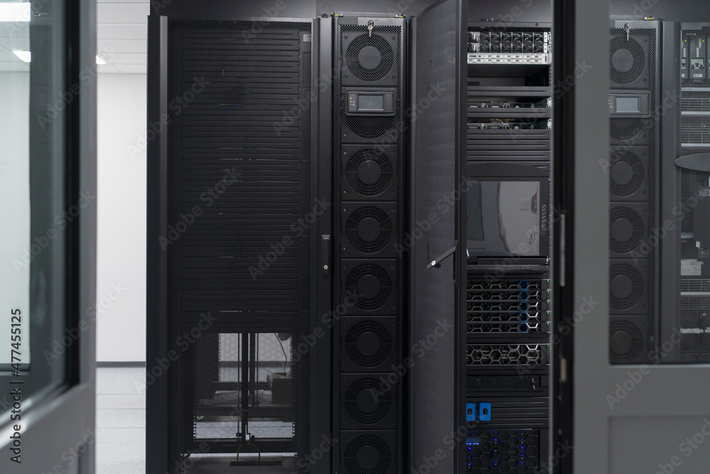 Data Center With Multiple Rows of Fully Operational Server Racks. Modern Telecommunications, Cloud Computing, Artificial Intelligence, Database, Supercomputer Technology Concept.