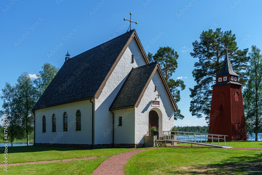 Sunny view of a church and clock tower in the Swedish countryside