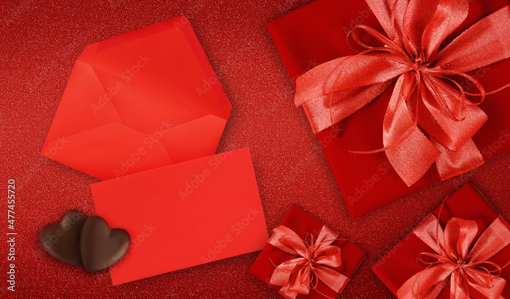 valentines day gift card, red boxes with red shiny ribbon bow, isolated on red background, blank layout ticket with copy space, heart shaped chocolates, top view and also for mother's day greetings valentines day gift card, red boxes with red shiny ribbon bow, isolated on red background, blank layout ticket with copy space, heart shaped chocolates, top view and also for mother's day greetings