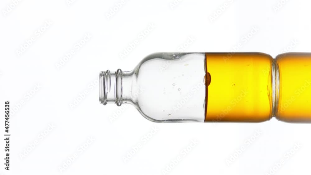 Drop of vitamin C falls down into transparent medical bottle with yellow clear fluid on white background | Abstract skincare cosmetics with vitamin C formulating concept Drop of vitamin C falls down into transparent medical bottle with yellow clear fluid on white background | Abstract skincare cosmetics with vitamin C formulating concept