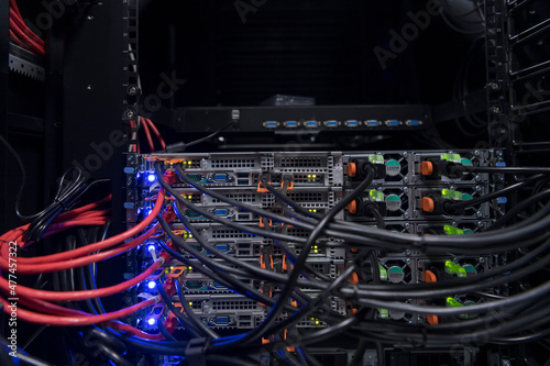 network server room closeup on fiber optic hub or switch for digital communications and internet in mainframe corporate business data center supercomputer. 