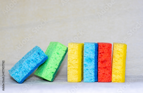 Multicolored sponges for cleaning. blue, green, red, yellow, blue and green colors. space for text.
Kitchen cleaning set sponge background.  photo