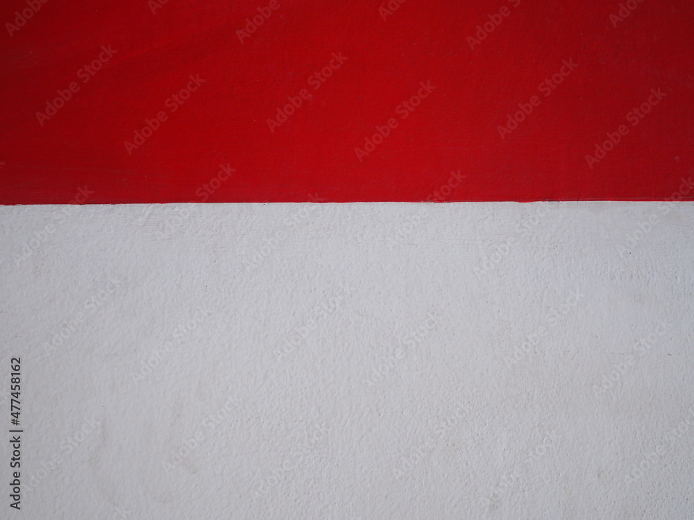 The cement walls are clearly divided into white and red tones. Paint on the walls to add beauty to the old walls. Suitable for backgrounds and textures. The proportion of red walls is less than white.