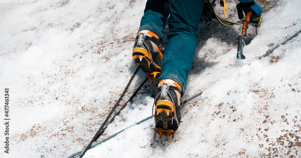 Man is climbing with crampons on the glacier. Man is climbing with crampons on the glacier.