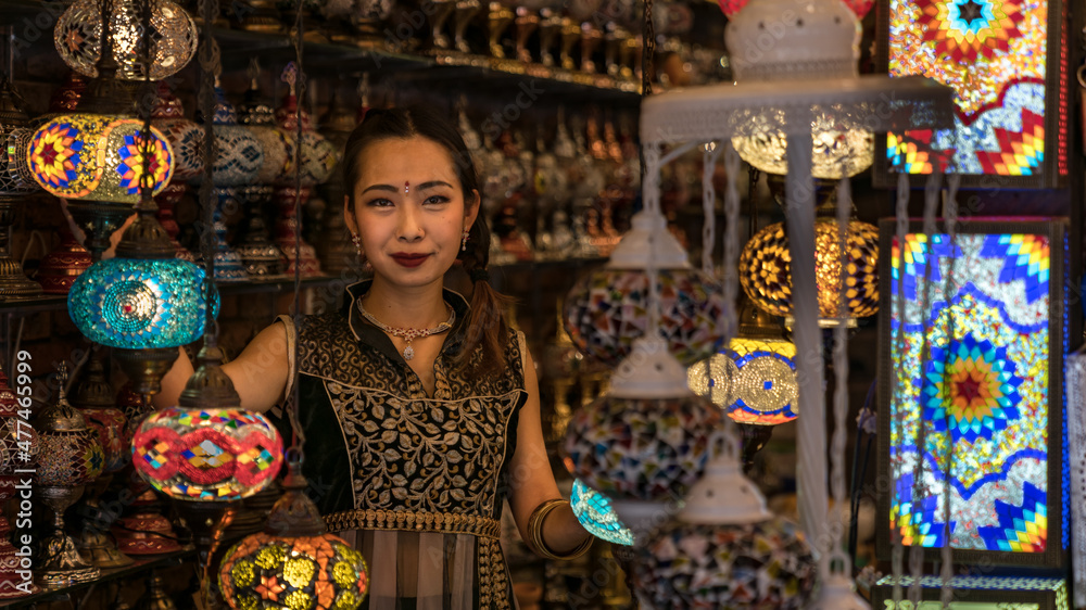 Chinese girl in a lamp shop