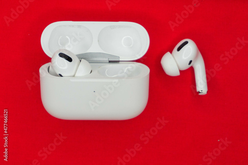 Wireless headphones white, photo on a red background