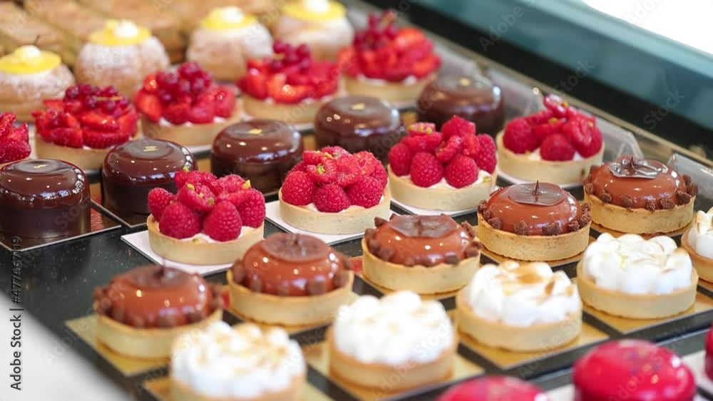 Pano right over assortment luxurious pastries and tarts in counter of a bakery shop