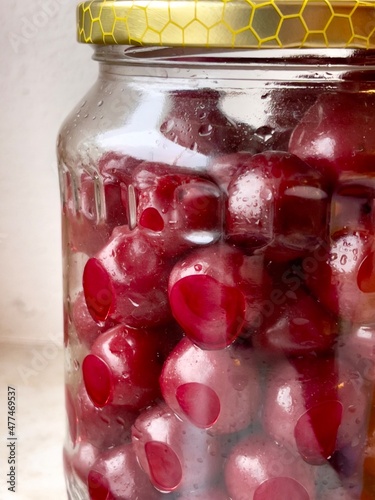 Glass jar with preserved cherries