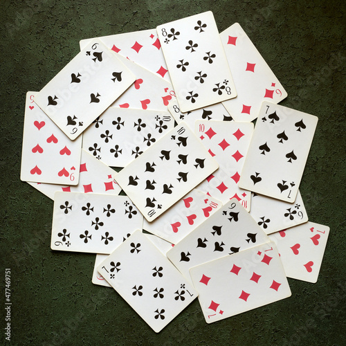 Old playing cards scattered on the table