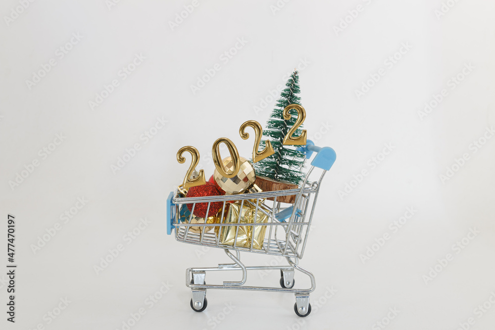 Happy new year concept 2022,christmas tree and ball in a shopping trolley  on white background