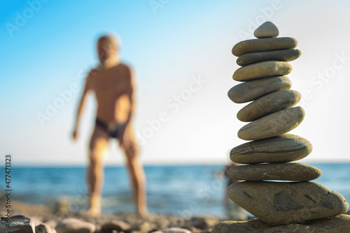 beach pebble stones pyramid on sea shore photo