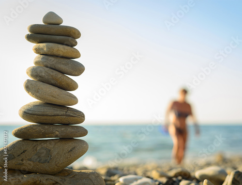 beach pebble stones pyramid on sea shore photo
