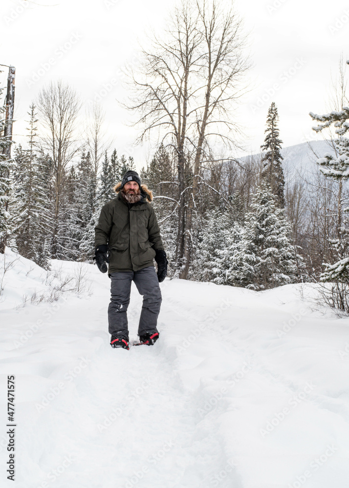 Man Snowshoeing in the Forest 