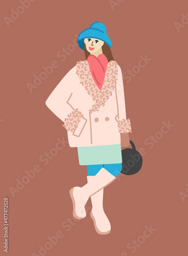 A woman in a hat, an elongated coat, a narrow mini skirt, and high boots. A girl in winter clothes in boho style.
