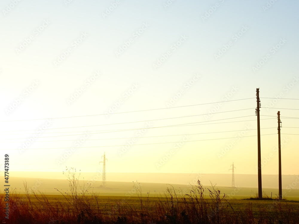 Foggy Sunrise Horizon with Power Pole Silhouettes