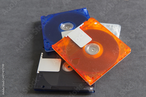 mini disc for data and music record with white background, Colorful mini disks - beautiful retro disks, mini md disk in hand woman with background red color.