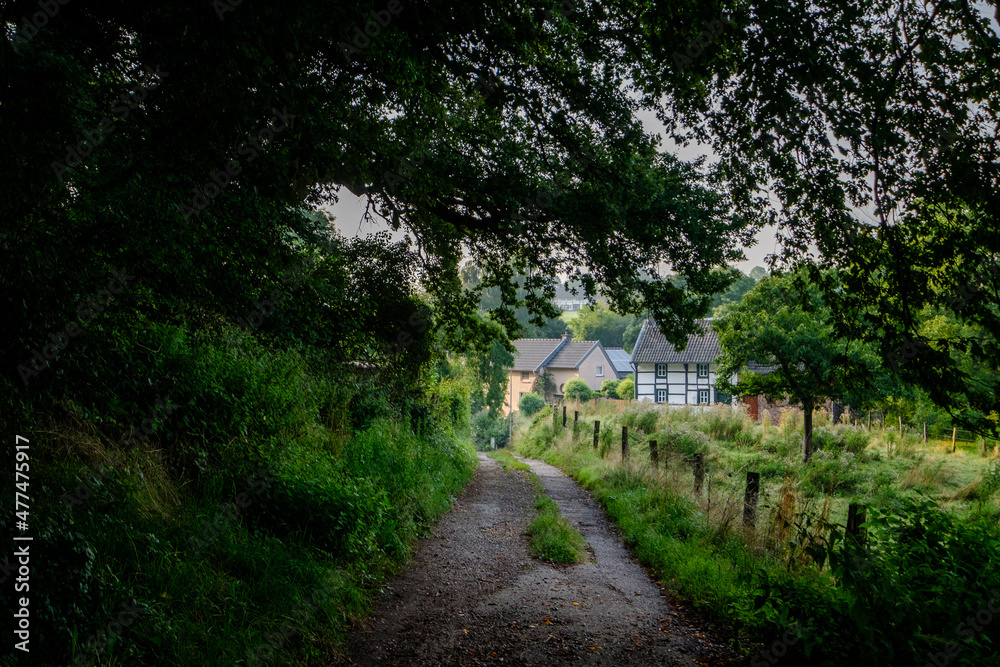 Path trough hills near old houses Path trough hills near old houses